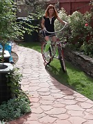 Cindy rides her bike and then strips naked outdoors - picture #1