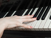 Sasha K strips naked and spreads her body over piano - picture #3