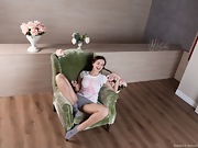 Ramira strips naked on her green armchair - picture #5
