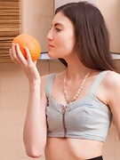 Maia juguetea con una naranja mientras se desnuda - picture #5