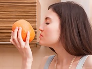 Maia juguetea con una naranja mientras se desnuda - picture #6