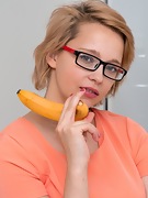 Uli enjoys a banana and orgasms in her kitchen - picture #2