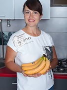 Animee enjoys a banana in her kitchen - picture #10