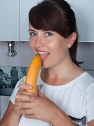 Animee enjoys a banana in her kitchen - picture #14