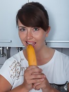 Animee enjoys a banana in her kitchen - picture #17