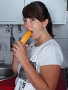 Animee enjoys a banana in her kitchen - picture #23