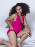 Divine poses in a sexy pink dress in bed - picture #8