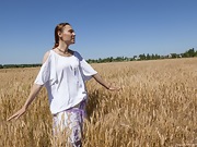 Nata strips naked outside in her wheat field - picture #1