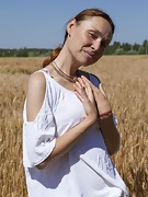 Nata strips naked outside in her wheat field - picture #3