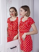 Anolia strips off her red dotted dress in bed - picture #1