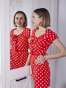 Anolia strips off her red dotted dress in bed - picture #4