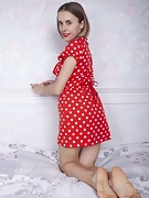 Anolia strips off her red dotted dress in bed - picture #12