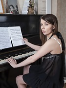Christy masturbates by her black piano - picture #3
