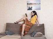 Vita strips naked on her sofa after reading a book - picture #4