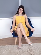 Zoe strips naked on her blue armchair - picture #2