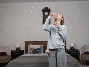 Anny gets naked after blowing bubbles by her bed - picture #3